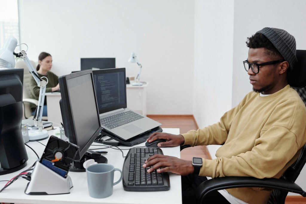Man sat at a desk typing on a keyboard