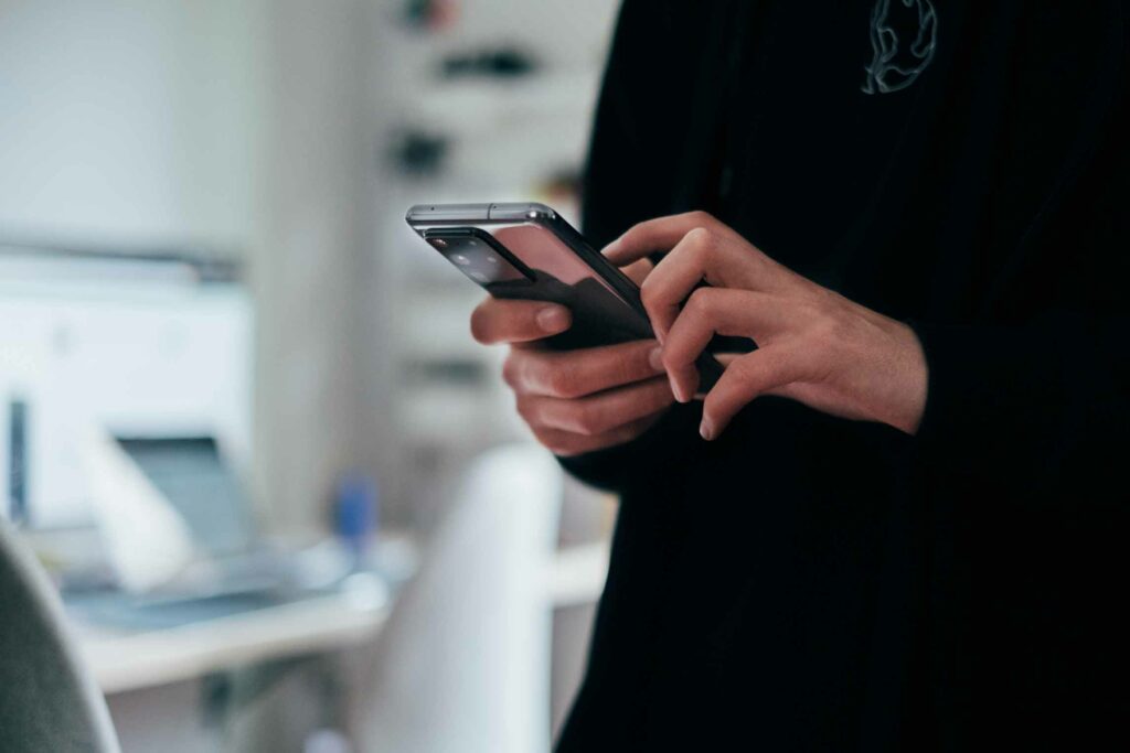 a pair of hands holding a phone