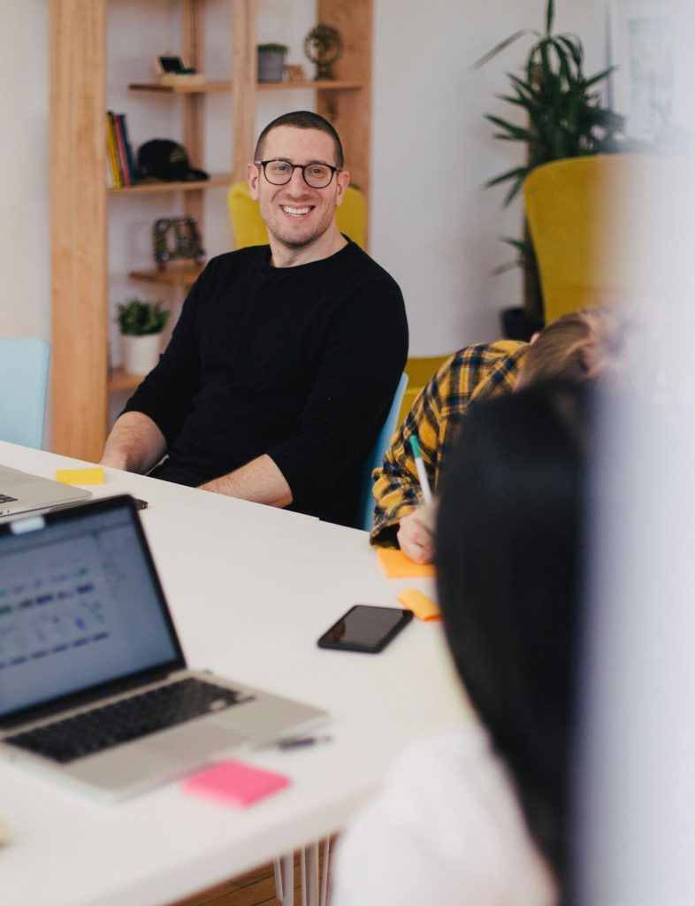 man smiling at a desk