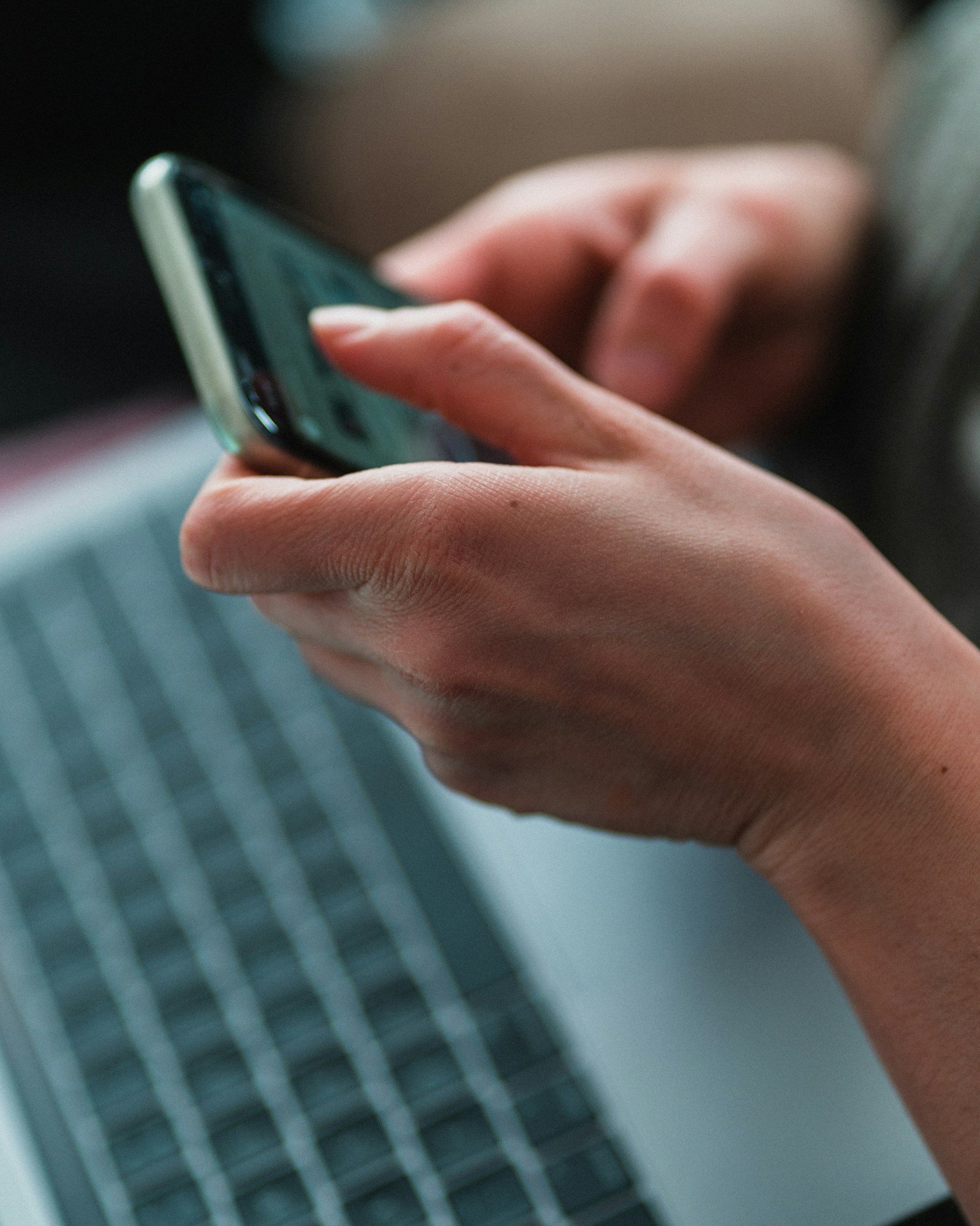 pair of hands with a mobile phone