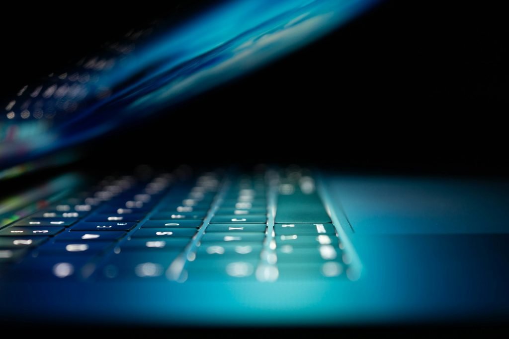 close up of a glowing laptop screen and keyboard