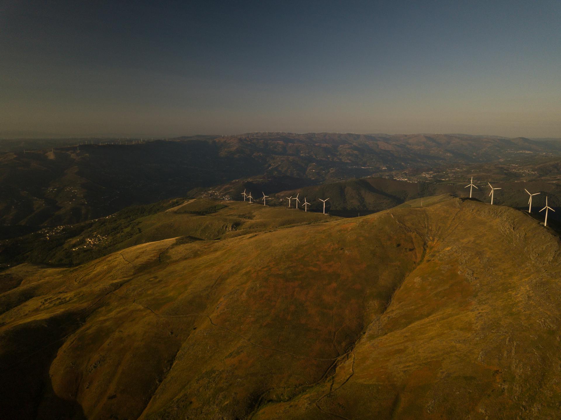 white turbines on hills aerial view