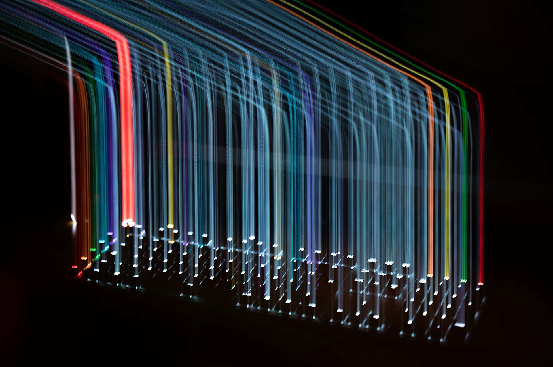 a long exposure of coloured lights on a keyboard