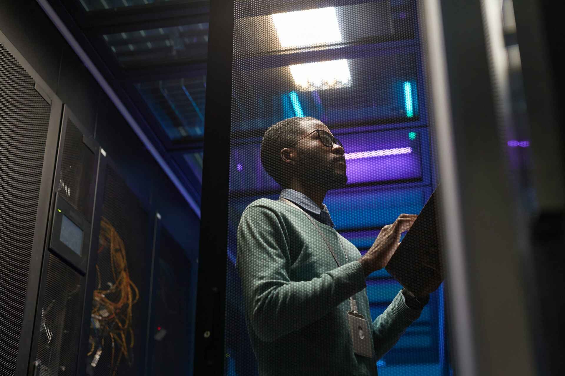 Network technician working in a server room