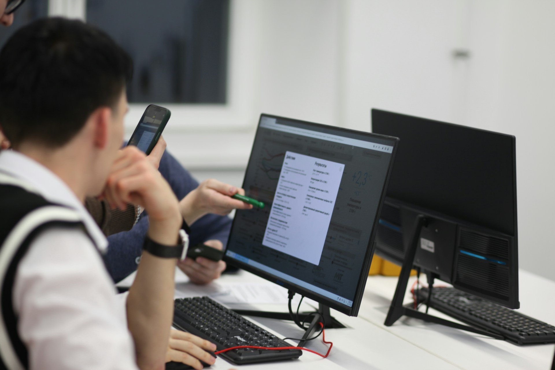 co-workers looking at a computer screen, working together